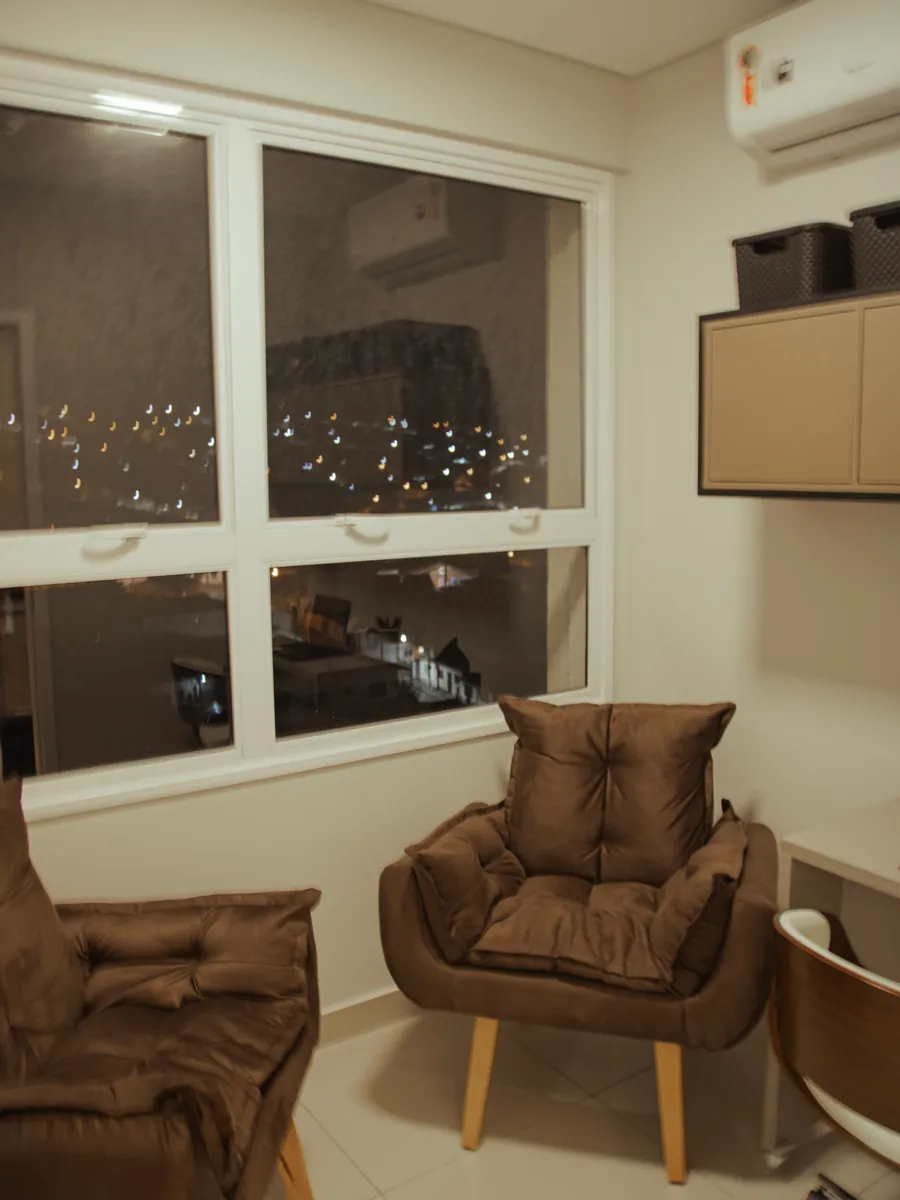 Sala de atendimento com poltronas junto à janela